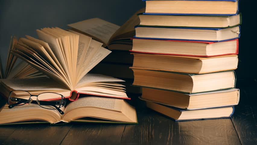 Books with glasses on top